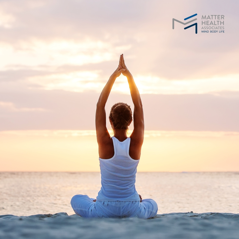 Finding Balance Using Movement to Manage Stress Naturally | Person practicing yoga outdoors at sunset to relieve stress and promote mental well-being through gentle exercise.