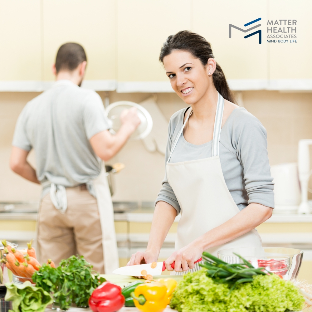 Listening to Your Body Preparing Meals with Purpose and Nourishment | Person preparing a healthy, colorful meal in a bright kitchen, representing intuitive eating based on body needs and natural food choices.