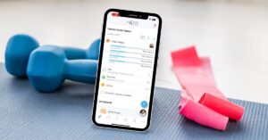 Dumbbells and workout bands surrounding a smartphone displaying the UI of Matter Health Associates’ personalized fitness and nutrition app.
