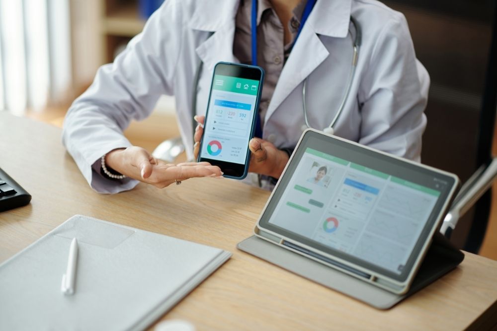 A health professional consultant showing health statistics on a mobile phone