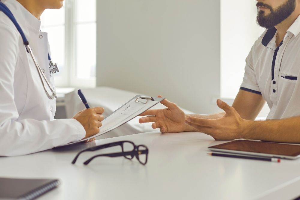 A male health professional consultant discussing a personalized wellness plan with his client