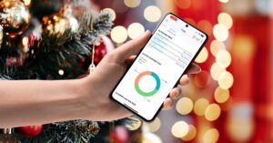 A hand holding a phone with Matter Health Associate App UI. Christmas background.