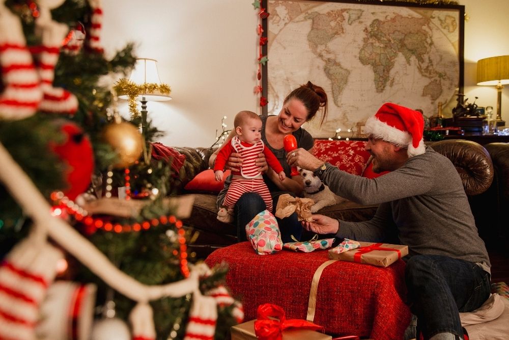 A photo of a happy family inside their home celebrating Christmas season