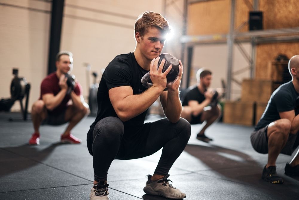 A man performing a focused workout to emphasize physical evolution over arbitrary numbers in health and nutrition.