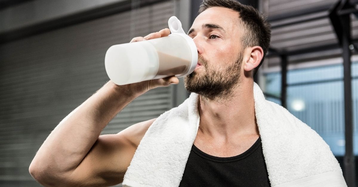 A man drinking a shake, illustrating when someone might typically use protein powder as a convenient supplement.