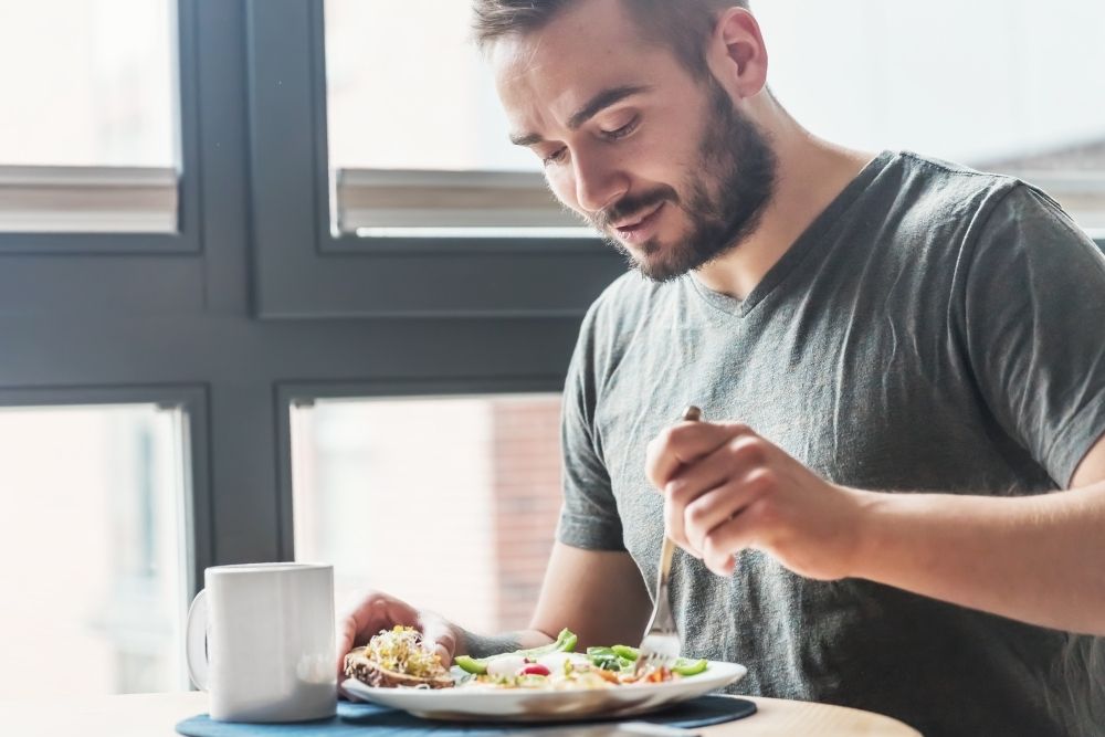 A man choosing healthy whole foods over sweets.