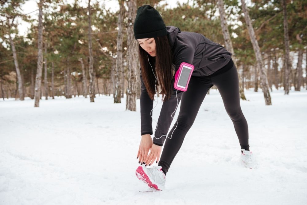 A woman practicing mobility exercises outdoors to maintain posture.