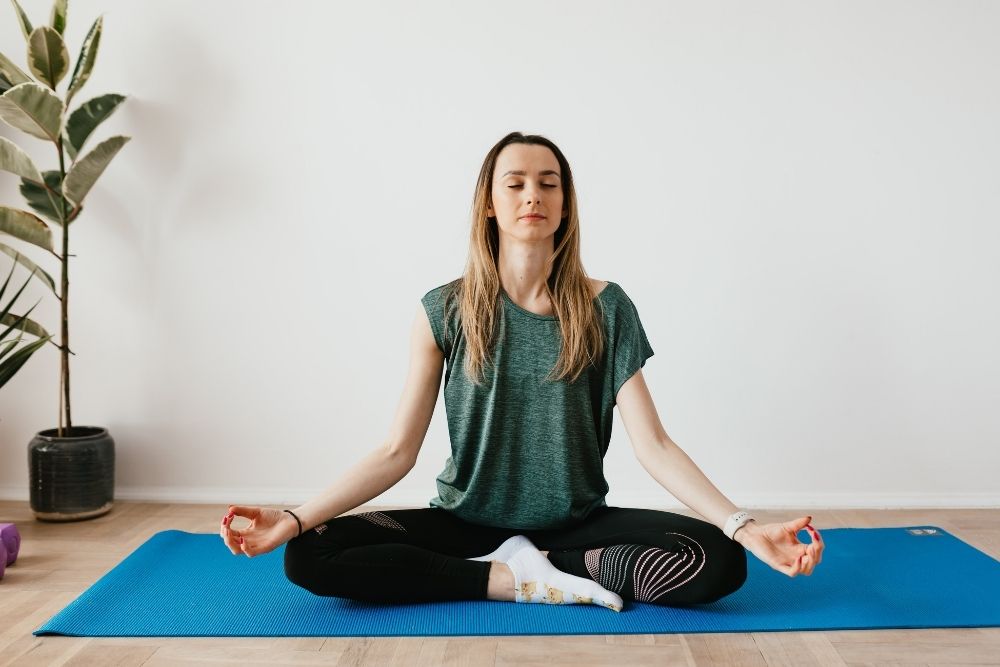 A woman practicing yoga with determination.