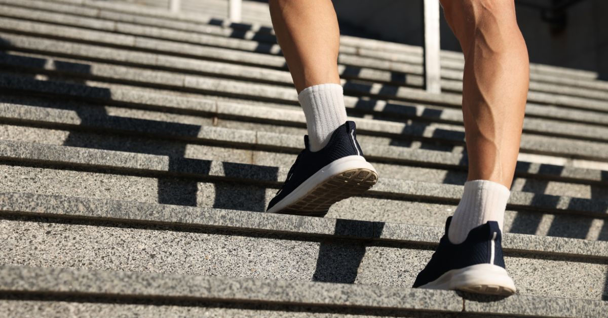 A close-up shot of athletic shoes taking a first step to sustainable fitness