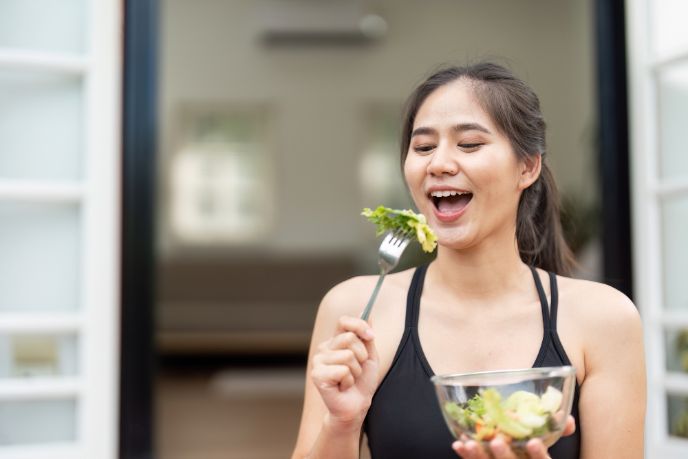 A happy, healthy person enjoying a balanced meal