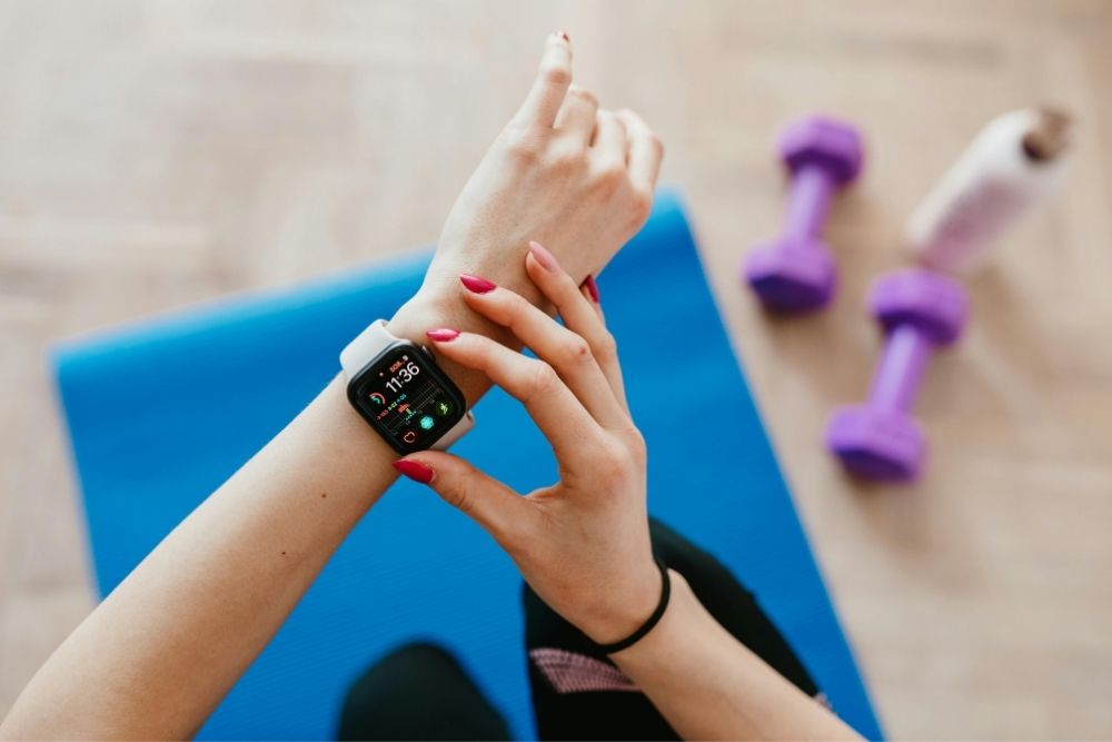 Close-up of a person wearing a fitness tracker, illustrating how the body adapts to different activity levels and stress.