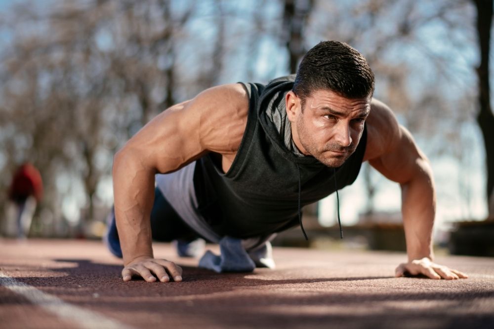 An athlete performing core push-ups to build strength for outdoor performance.