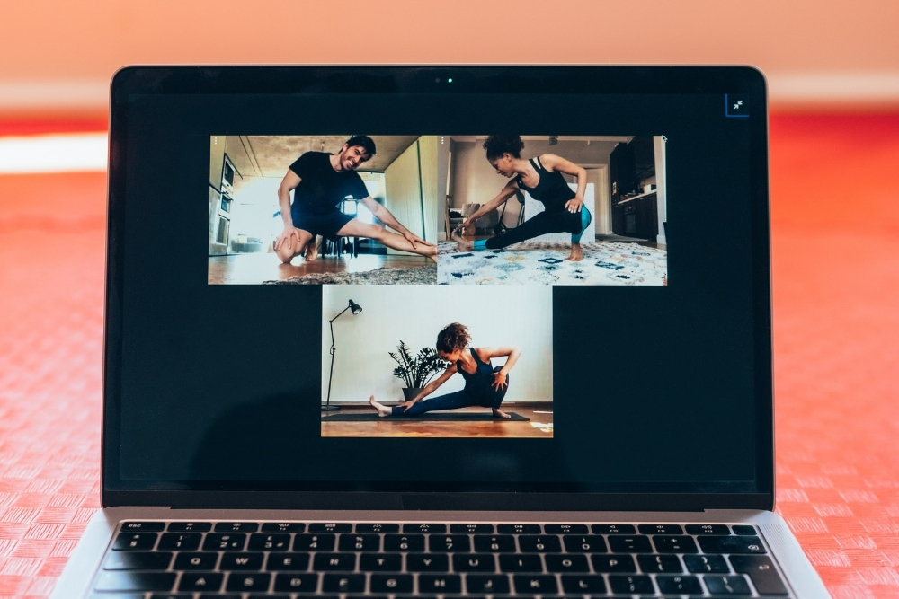 A laptop screen displaying a virtual fitness coaching session, highlighting the digital tools used in modern online workout programs.